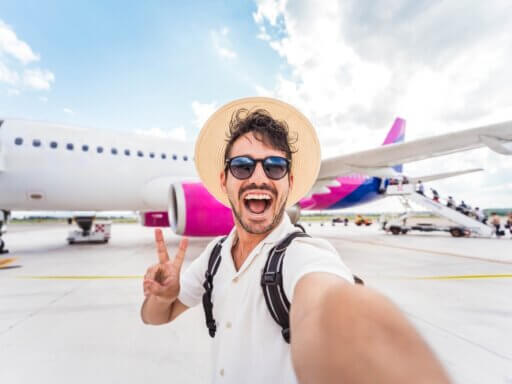 Mann auf Alleinreisen vor einem Flugzeug